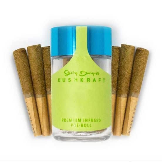 Close-up of KushKraft 6 Pack Infused Sticky Banger Pre-Rolls, featuring six 0.5g joints shimmering with kief over 24K Gold buds infused with THC distillate.