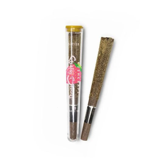 Close-up of a Shatter Blunt 1g Sativa, featuring a 1g pre-roll glistening with THC distillate and hash, infused with Super Lemon Haze.